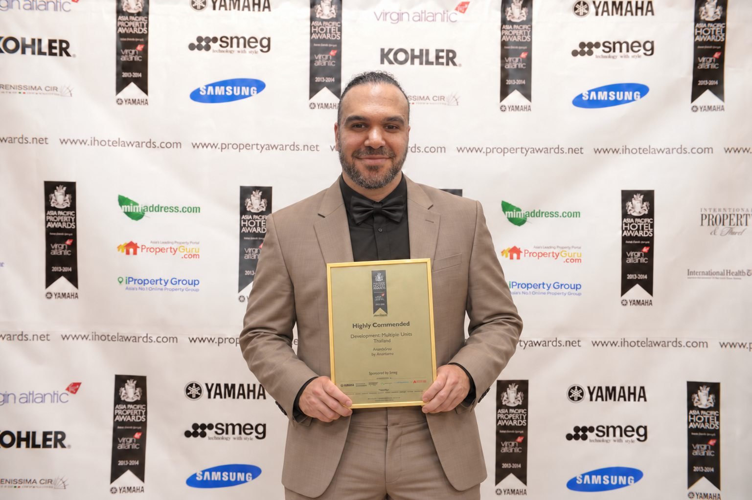 Antonio Doani holding a Highly Commended certificate at the 2013 Asia Pacific Property Awards