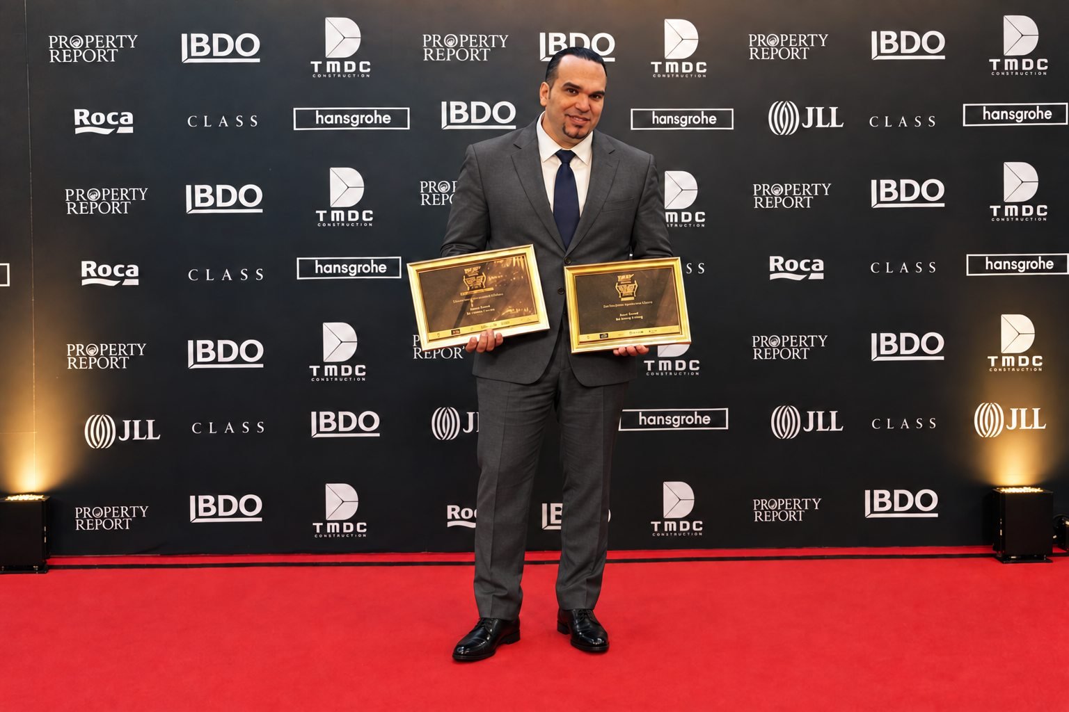 Antonio Doani holding two certificates at the 2015 Thailand Property Awards