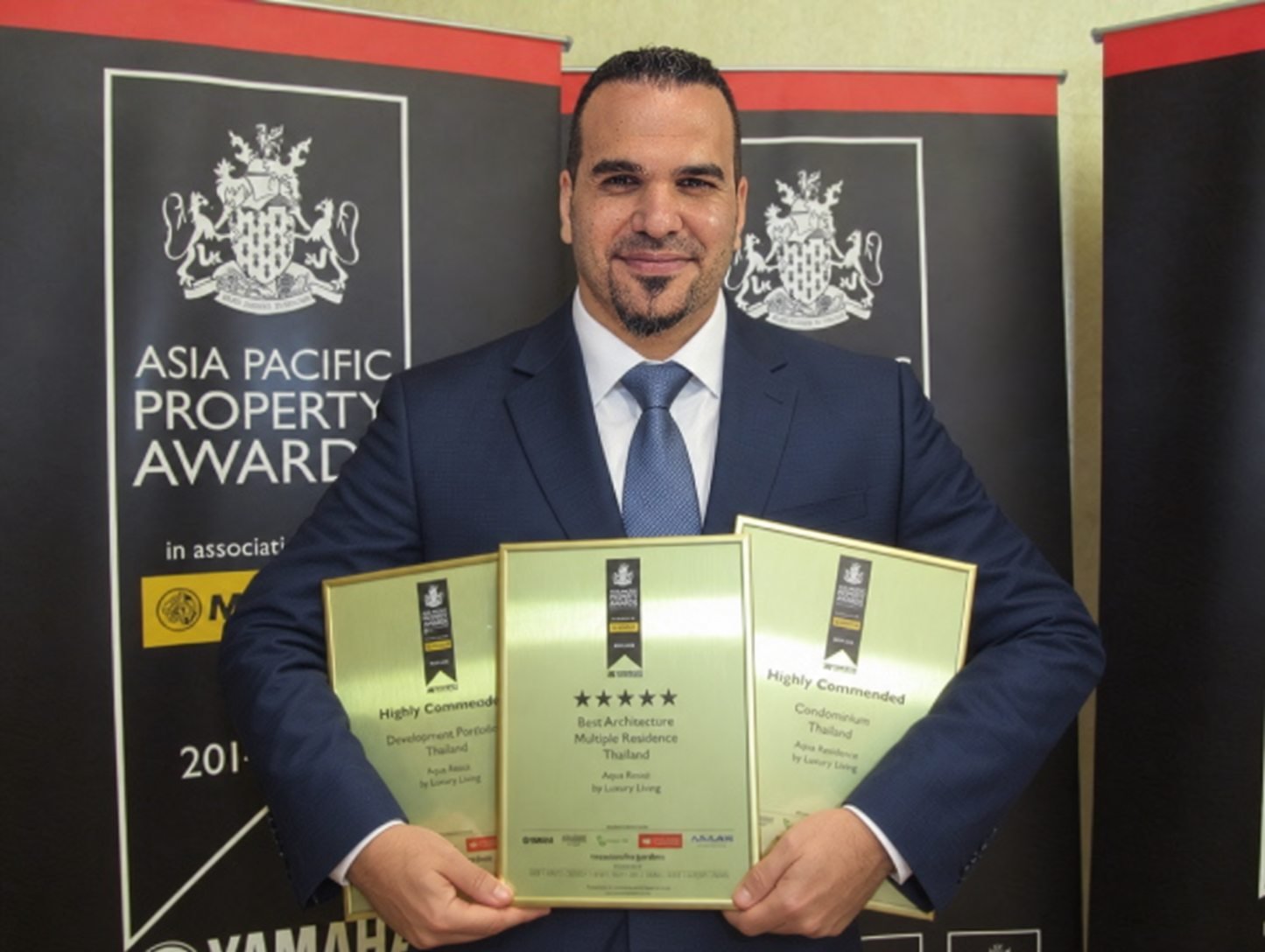 Antonio Doani holding three Asia Pacific Property Awards certificates in 2014